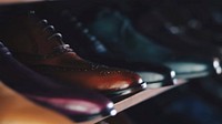 Various leather boots and shoes lined up on a shelf. Original public domain image from Wikimedia Commons