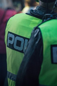 Person wearing a police uniform. Original public domain image from <a href="https://commons.wikimedia.org/wiki/File:Daniel_Tafjord_2017_(Unsplash).jpg" target="_blank">Wikimedia Commons</a>