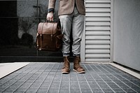A low shot of a man in leather boots carrying a brown leather bag. Original public domain image from <a href="https://commons.wikimedia.org/wiki/File:READY_(Unsplash).jpg" target="_blank" rel="noopener noreferrer nofollow">Wikimedia Commons</a>