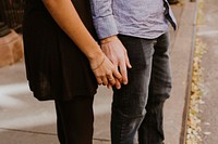 Woman touching the hands of a man on the street. Original public domain image from Wikimedia Commons