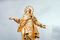 Gold religious statue of figure wearing regal halo in heavenly pose, Milan. Original public domain image from Wikimedia Commons