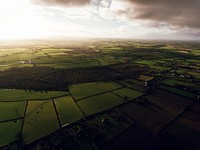 A rural landscape with a patchwork of green fields on a cloudy day. Original public domain image from Wikimedia Commons