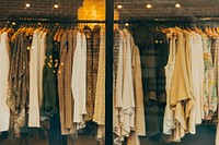 Blouses, jackets and sweater on hangers in a store window. Original public domain image from Wikimedia Commons