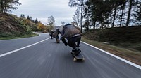 Three skateboarders speeding on an asphalt road. Original public domain image from Wikimedia Commons