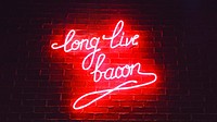 A red neon sign reads "Long live bacon" on a brick wall of Lazy Bastard. Original public domain image from Wikimedia Commons