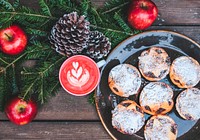 A festive set up of apples, pine leaves, acorns, and mince pies in London. Original public domain image from Wikimedia Commons