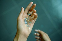 Hand holding glittering stars. Original public domain image from Wikimedia Commons