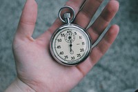 A pocket watch in a person's open hand. Original public domain image from Wikimedia Commons