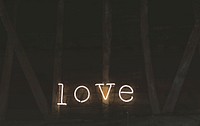 Neon lights spell out love against a wooden barn wall. Original public domain image from <a href="https://commons.wikimedia.org/wiki/File:Neon_love_sign_(Unsplash).jpg" target="_blank" rel="noopener noreferrer nofollow">Wikimedia Commons</a>