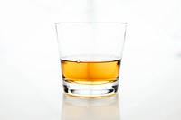 The macro view of a glass cup containing whiskey in a white background. Original public domain image from <a href="https://commons.wikimedia.org/wiki/File:Drink_Up!_(Unsplash).jpg" target="_blank" rel="noopener noreferrer nofollow">Wikimedia Commons</a>