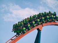 Roller coaster on red track with excited people. Original public domain image from Wikimedia Commons