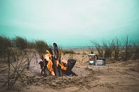 Kettle and a cup on a stand by the large fire in the sand hole. Original public domain image from Wikimedia Commons