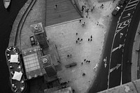 A drone shot of pedestrians on a waterfront. Original public domain image from Wikimedia Commons