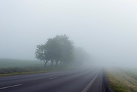 A country road disappears into a foggy horizon. Original public domain image from Wikimedia Commons