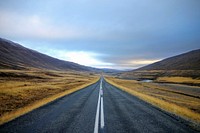 Road leading to mountains alongside with grass fields. Original public domain image from Wikimedia Commons