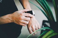 Person about to use silver Apple Watch  in grey sports band. Original public domain image from <a href="https://commons.wikimedia.org/wiki/File:Nick_Jio_2017_(Unsplash).jpg" target="_blank">Wikimedia Commons</a>