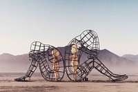 Architecture of two persons turning their backs to one another at Burning Man. Original public domain image from Wikimedia Commons