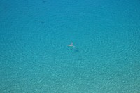 Aerial photo of person swimming on body in the blue clear sea during daytime. Original public domain image from <a href="https://commons.wikimedia.org/wiki/File:Tropea,_Italy_(Unsplash).jpg" target="_blank">Wikimedia Commons</a>