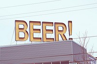 A beer sign with small lights on it on a bar. Original public domain image from Wikimedia Commons