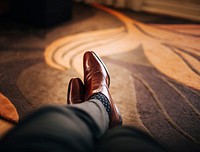 A man wearing a pair of brown leather shoes lying on the floor mat. Original public domain image from <a href="https://commons.wikimedia.org/wiki/File:Letchworth_Garden_City,_United_Kingdom_(Unsplash_OuxPfti70I0).jpg" target="_blank">Wikimedia Commons</a>