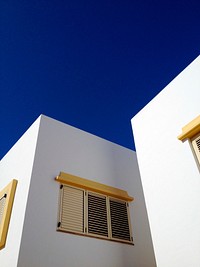 White houses contrasting with blue sky. Original public domain image from Wikimedia Commons