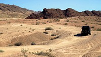 off-roader truck drives through rough terrain of the desert in Las Vegas. Original public domain image from Wikimedia Commons