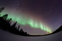 Northern light shining bright in the starry night sky. Original public domain image from Wikimedia Commons