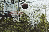 Basketball over a hoop. Original public domain image from <a href="https://commons.wikimedia.org/wiki/File:Noah_Silliman_2017-04-24_(Unsplash).jpg" target="_blank">Wikimedia Commons</a>