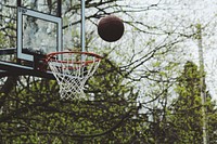 Basketball over a hoop. Original public domain image from Wikimedia Commons