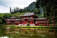 A bright red Japanese-style home alongside a green pond surrounded by trees and mountains. Original public domain image from Wikimedia Commons