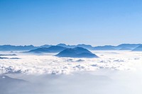 The crest of the Dent de Crolles mountain jutting out from a sea of clouds. Original public domain image from Wikimedia Commons