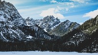 A wintry scenery with craggy mountain crests and wooded slopes near Lago di Braies. Original public domain image from <a href="https://commons.wikimedia.org/wiki/File:Day_12_unsplashdaily_(Unsplash).jpg" target="_blank" rel="noopener noreferrer nofollow">Wikimedia Commons</a>