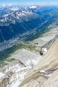 A gondola lift over a steep rocky mountain slope. Original public domain image from <a href="https://commons.wikimedia.org/wiki/File:Mont_Blanc_lift_(Unsplash).jpg" target="_blank" rel="noopener noreferrer nofollow">Wikimedia Commons</a>