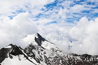 The snow-capped Kitzsteinhorn mountain enveloped in dense clouds. Original public domain image from Wikimedia Commons