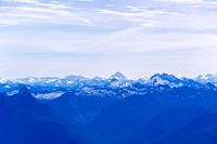 The sharp peak of Mount Pilchuck on the horizon rising up above a hazy mountain range. Original public domain image from <a href="https://commons.wikimedia.org/wiki/File:Mount_Pilchuck_on_the_horizon_(Unsplash).jpg" target="_blank" rel="noopener noreferrer nofollow">Wikimedia Commons</a>