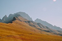 Ascent to a mountainous hill with orange, ocher ground on a cloudless day. Original public domain image from Wikimedia Commons