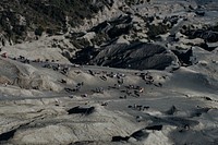 A high shot of a group of people and horses on the rocky slope of a mountain. Original public domain image from Wikimedia Commons