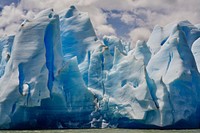 A blue and white glacier with several peaks jutting towards the sky. Original public domain image from Wikimedia Commons