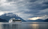 A cruise ship on a mountain lake with heavy clouds above. Original public domain image from <a href="https://commons.wikimedia.org/wiki/File:Independence_of_the_Seas_(Unsplash).jpg" target="_blank" rel="noopener noreferrer nofollow">Wikimedia Commons</a>