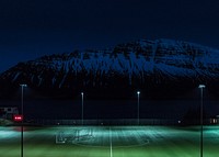 Turf soccer pitch illuminated by floodlights under the snow covered hill at night. Original public domain image from <a href="https://commons.wikimedia.org/wiki/File:Training_(Unsplash).jpg" target="_blank" rel="noopener noreferrer nofollow">Wikimedia Commons</a>
