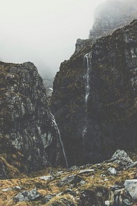 Waterfall on a scenic mountainside on a misty morning in Mount Aspiring National Park. Original public domain image from Wikimedia Commons