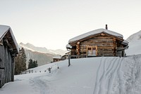 A cottage covered in snow with vehicle tracks at the Klosters Parsenn ski resort. Original public domain image from <a href="https://commons.wikimedia.org/wiki/File:Klosters_Parsenn_resort_(Unsplash).jpg" target="_blank" rel="noopener noreferrer nofollow">Wikimedia Commons</a>