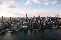 Skyline of New York under fluffy clouds. Original public domain image from <a href="https://commons.wikimedia.org/wiki/File:Helicopter_(Unsplash).jpg" target="_blank">Wikimedia Commons</a>