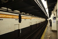 New York City underground subway station with people waiting for their train. Original public domain image from <a href="https://commons.wikimedia.org/wiki/File:15th_street_stop_(Unsplash).jpg" target="_blank" rel="noopener noreferrer nofollow">Wikimedia Commons</a>