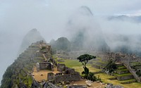 Historic ruins of Machu Picchu cover in fog. Original public domain image from Wikimedia Commons