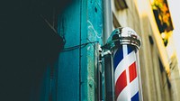 Barbershop red and white swirling pole capped by steel ends beside an aquamarine wall. Original public domain image from <a href="https://commons.wikimedia.org/wiki/File:Baber%27s_pole_up_close_(Unsplash).jpg" target="_blank" rel="noopener noreferrer nofollow">Wikimedia Commons</a>