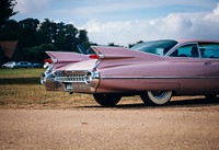 Pink vintage sport car park outside. Original public domain image from Wikimedia Commons