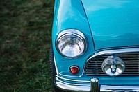 Headlight and hood details on a baby blue vintage car. Original public domain image from Wikimedia Commons