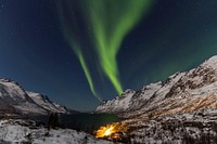 Brown mountain hills at green sky during night time in Ersfjorden, Norway. Original public domain image from Wikimedia Commons