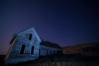 House on a field under night sky. HOriginal public domain image from Wikimedia Commons